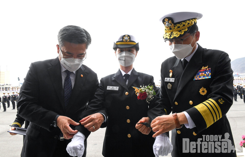 해군사관학교 연병장에서 거행된 제76기 해군사관생도 졸업 및 임관식에서 해군 임관대표 정예린 해군소위가 서욱 국방부장관(좌측), 김정수 해군참모총장(오른쪽)에게 계급장을 수여 받고 있다.(사진: 해군)